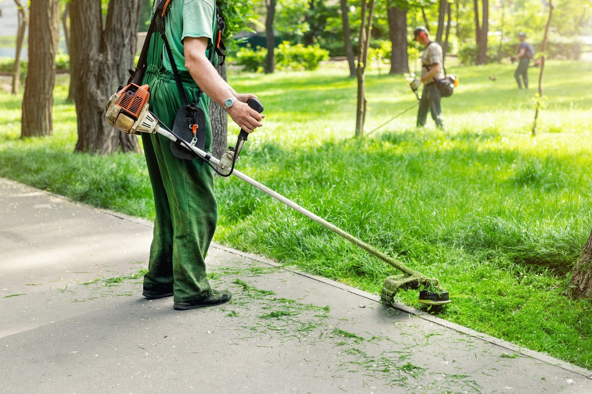 Landscaping crew with tablet checking schedule and route at property